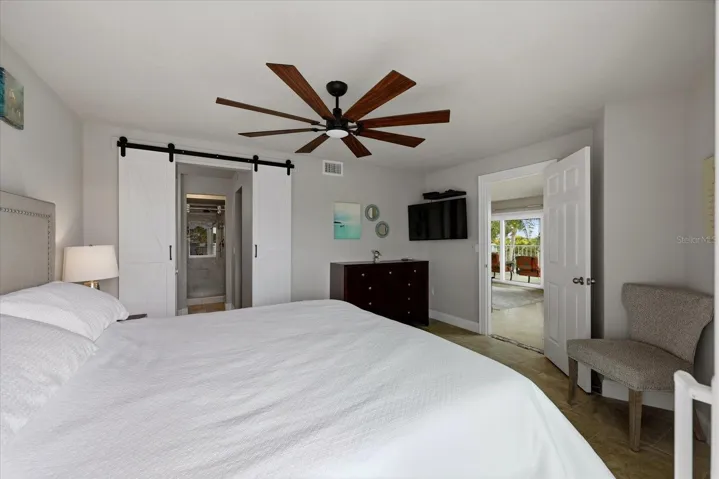 Barn doors leading to primary bathroom and closet