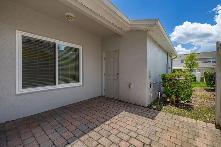 Private back patio covered from home to garage