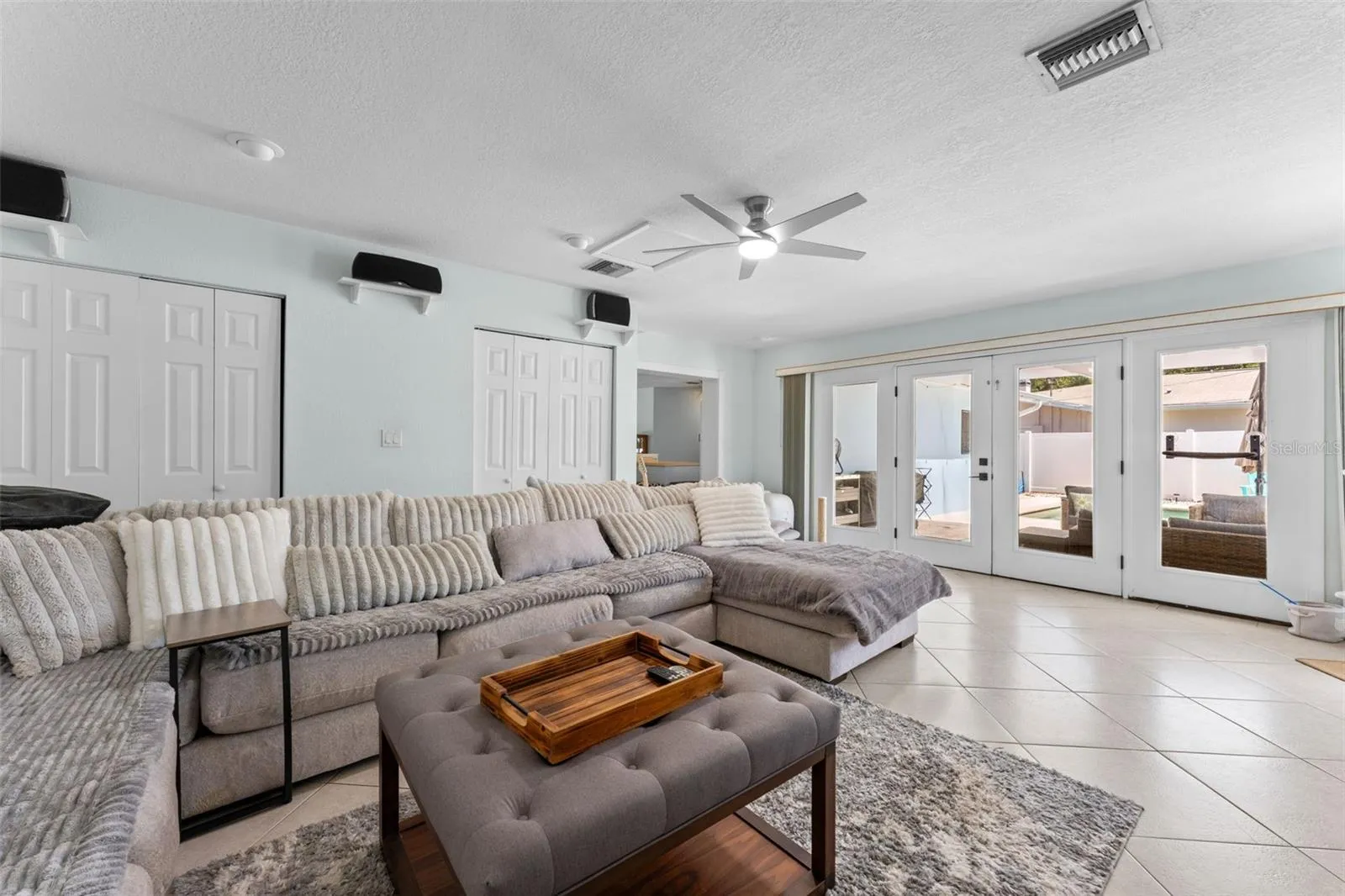 Extra large family room with french doors to pool