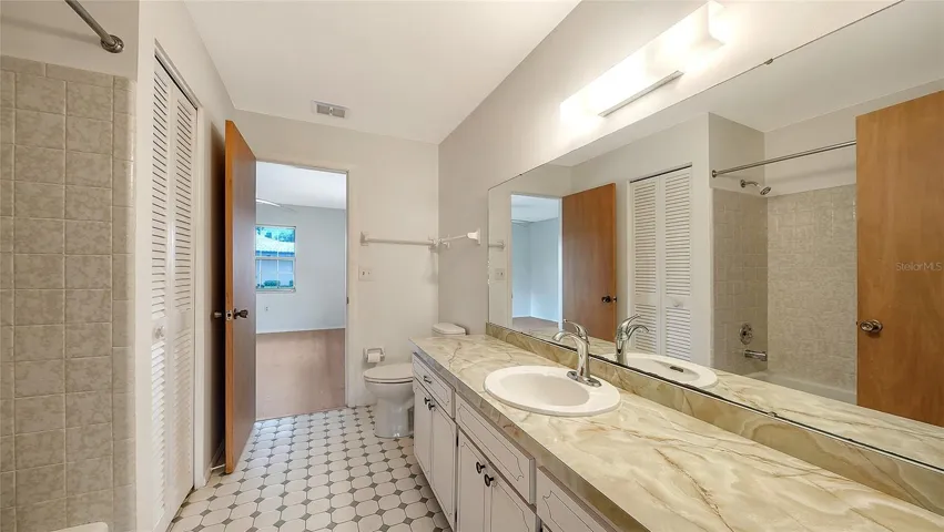 The second bath is accessible from both the second bedroom and the bonus area near the kitchen.