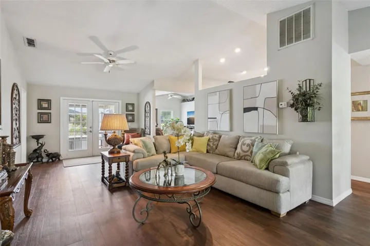 French doors in the living room showcase fabulous views of the backyard oasis