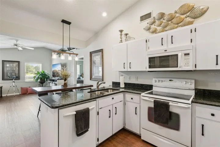 Breakfast Bar is enhance with granite countertops