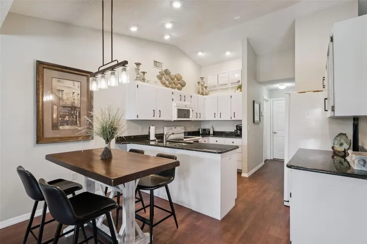 Charming breakfast Nook is adorned with a custom light fixture