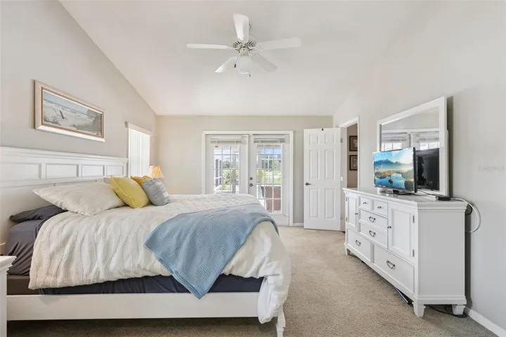 Private Primary Bedroom suite offers wonderful views of the pool & backyard