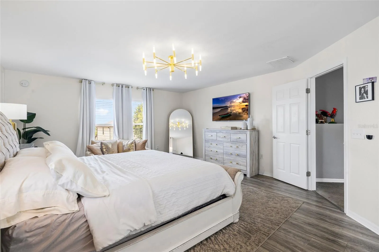 Oversized primary suite offering generous space, luxury flooring, and room for a private sitting area.