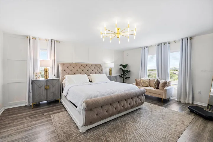Oversized primary suite offering generous space, luxury flooring, and room for a private sitting area.