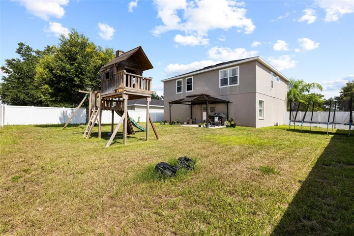 Expansive fenced backyard with plenty of room for entertaining, pets, outdoor activities, or a future pool.