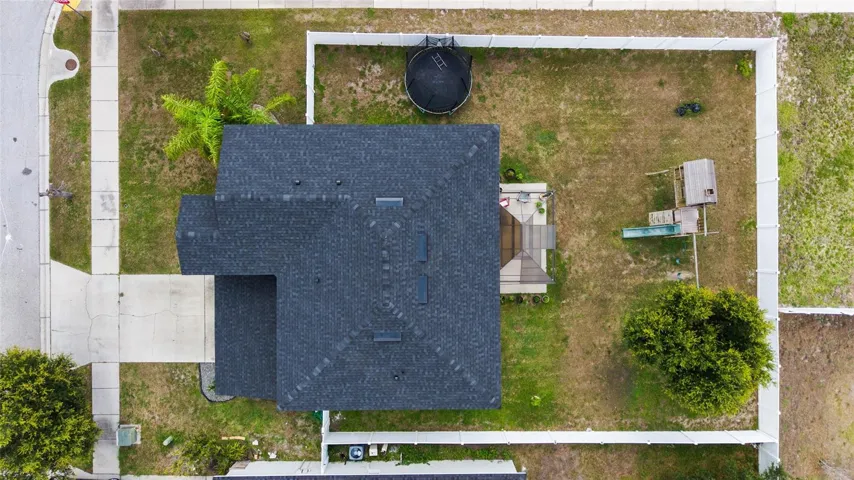 Drone shot Expansive fenced backyard with plenty of room for entertaining, pets, outdoor activities, or a future pool.