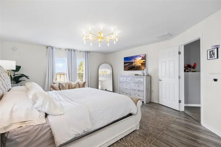 Oversized primary suite offering generous space, luxury flooring, and room for a private sitting area.