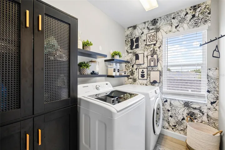 Dedicated laundry room with additional storage and functional workspace.