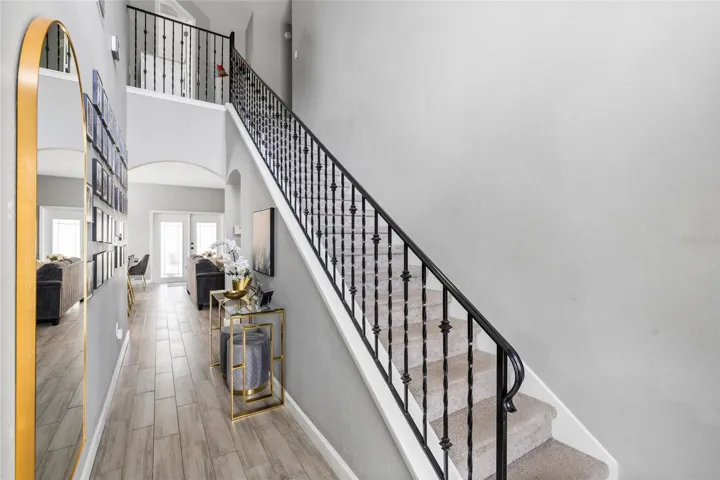 Grand entryway featuring soaring ceilings, abundant natural light, and an open-concept floor plan.