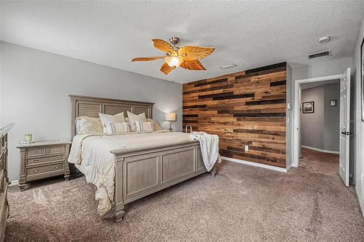Primary bedroom with custom accent wall