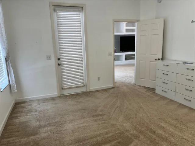 primary bedroom with door that opens to lanai