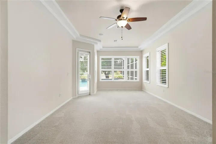 primary bedroom w/ view of lake & sitting area
