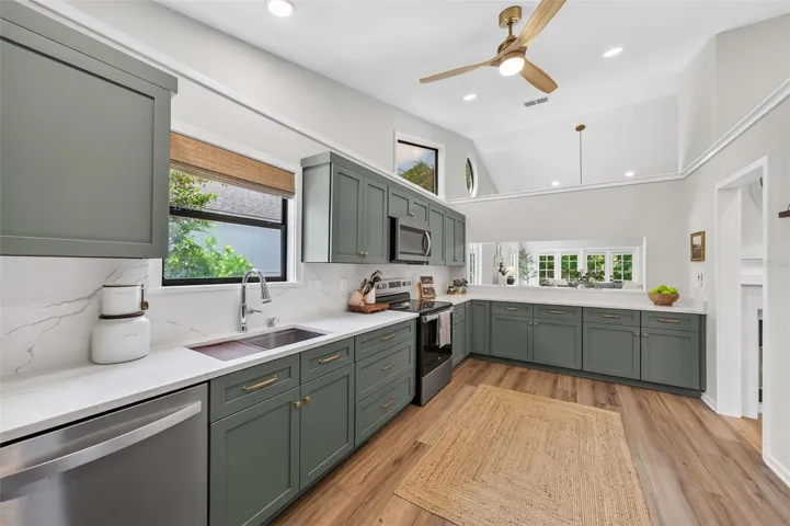 Oversized stainless workstation sink featuring built-in ledges for interchangeable accessories such as cutting boards and colanders.