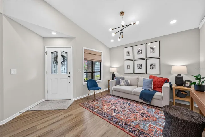 Living room with vaulted ceilings & new luxury vinyl flooring