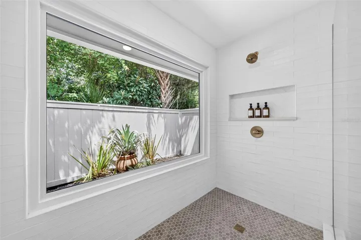 Owners suite walk in shower overlooking courtyard garden