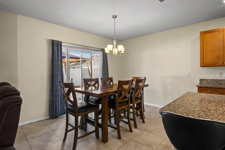 Dining room is right off the kitchen with sliders to the large backyard.