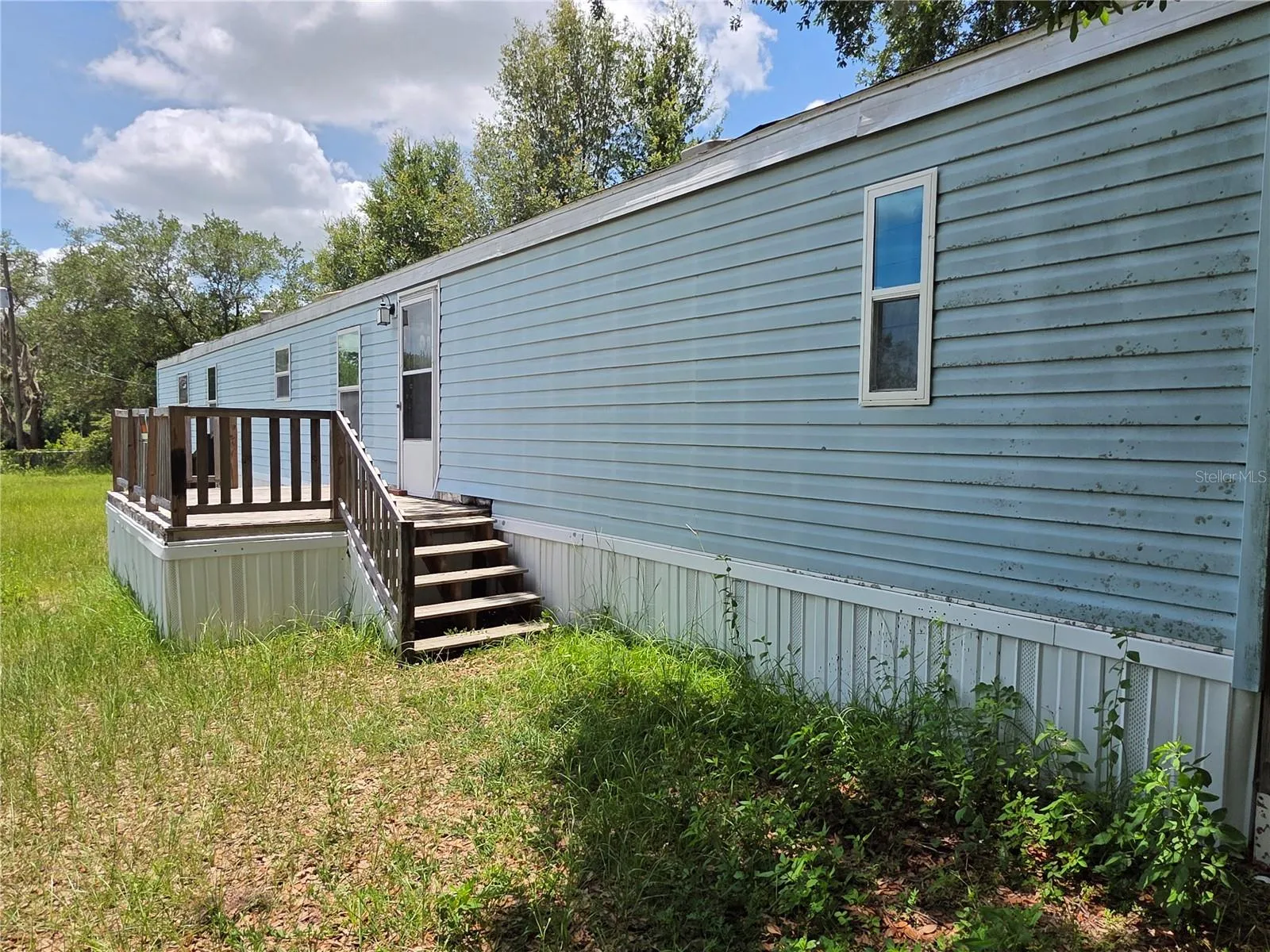 Front deck with stairs and ramp.