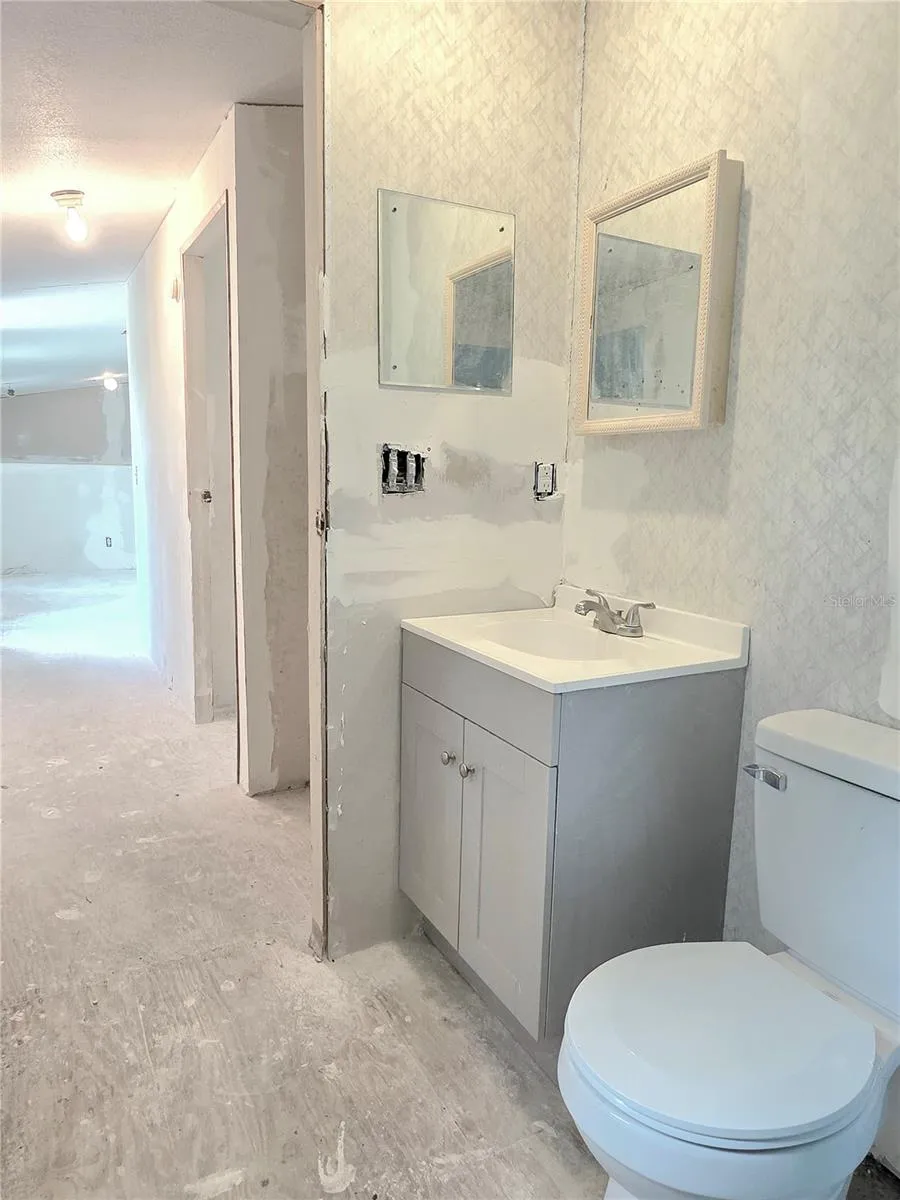 The main bathroom features an updated tub, vanity and shower