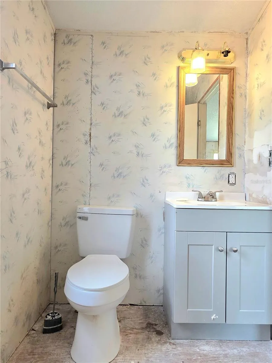 The in-suite bathroom features an updated vanity and shower surround.