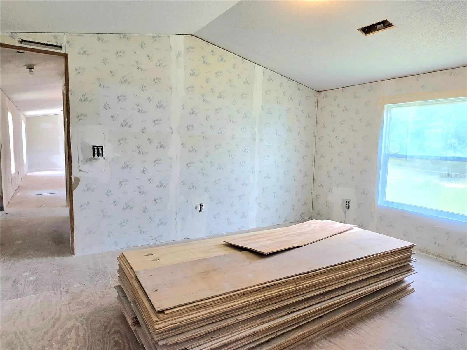 Primary bedroom featuring a walk-in closet and an en-suite bathroom.