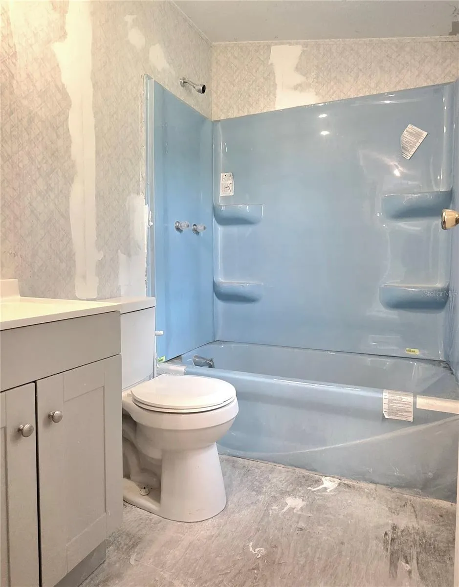 The main bathroom features an updated tub, vanity and shower.