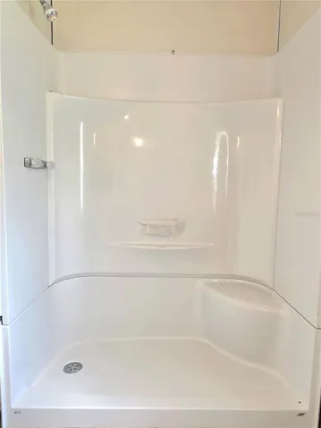 The in-suite bathroom features an updated vanity and shower surround.