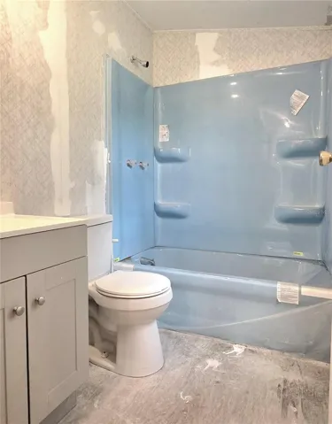 The main bathroom features an updated tub, vanity and shower.
