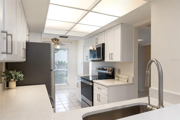 Charming kitchen with NEW CABINETS, QUARTZ COUNTERS & NEW STAINLESS STEEL APPLIANCES.