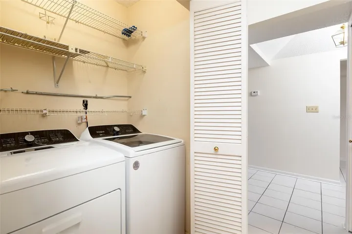 Inside laundry closet includes washer & dryer.