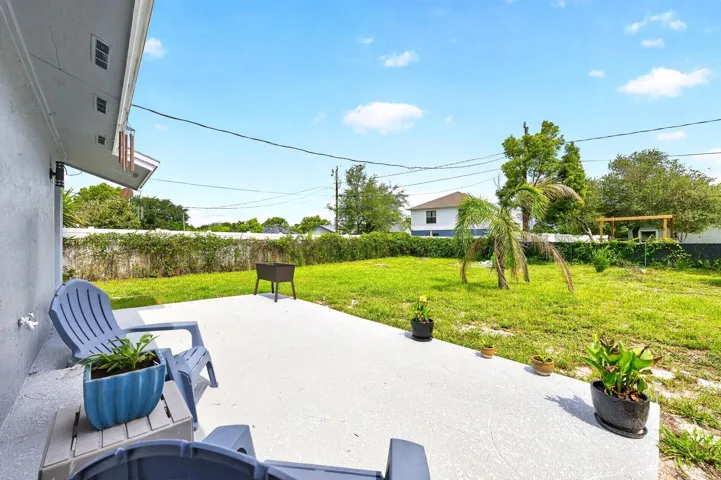 Step outside and enjoy the NEWLY ADDED BACK PATIO (2026) overlooking the large fenced backyard.