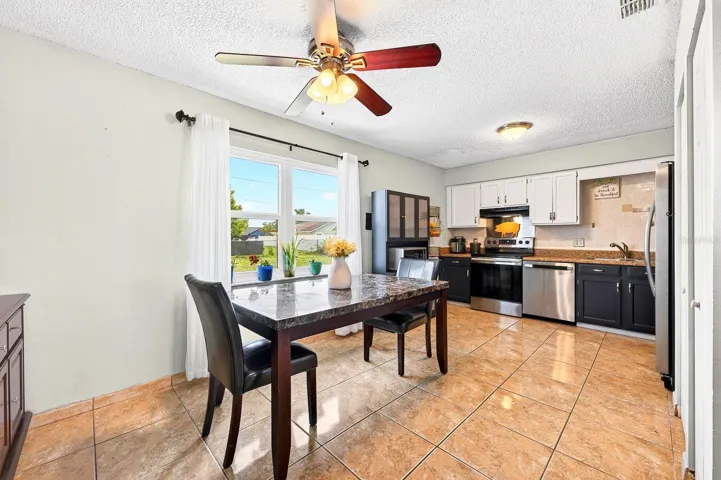 The Dining Area features a large window overlooking the EXPANSIVE BACKYARD, bringing the outdoors in.