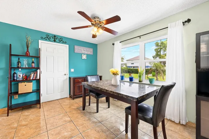 The Dining Area features a large window overlooking the EXPANSIVE BACKYARD, bringing the outdoors in.