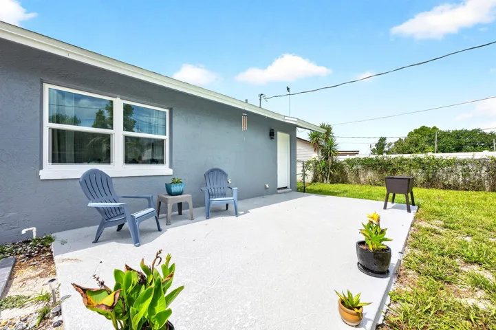 Step outside and enjoy the NEWLY ADDED BACK PATIO (2026) overlooking the large fenced backyard.