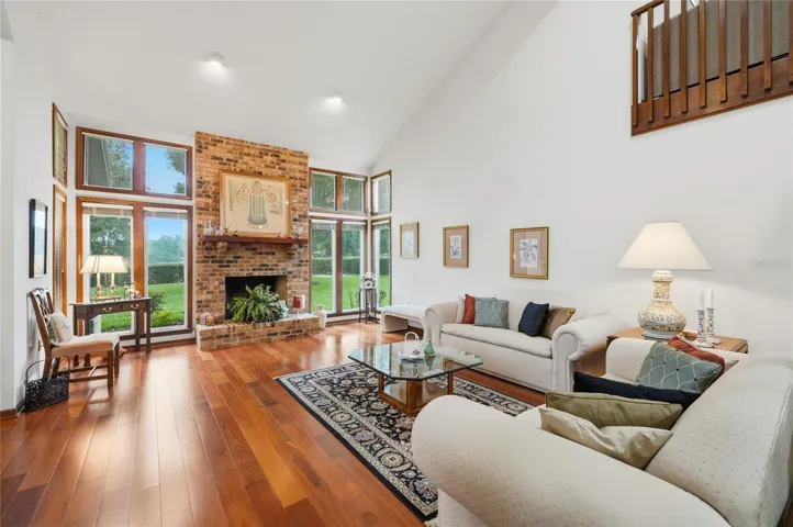 Living Area with Floor to Ceiling Brick Fireplace and Vaulted Ceiling.