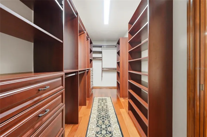 Primary Suite Walk In Closet with Double Entry Pocker Doors