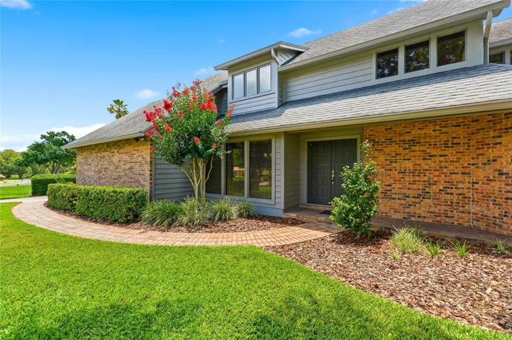 Brick Accents with Brick Entry Sidewalk and Covered Front Stoop.
