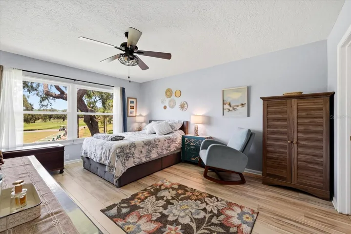 Primary bedroom with view of golf course.