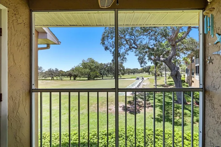 View from screened patio with storage closet. 2026 Hurricane rated slider door.
