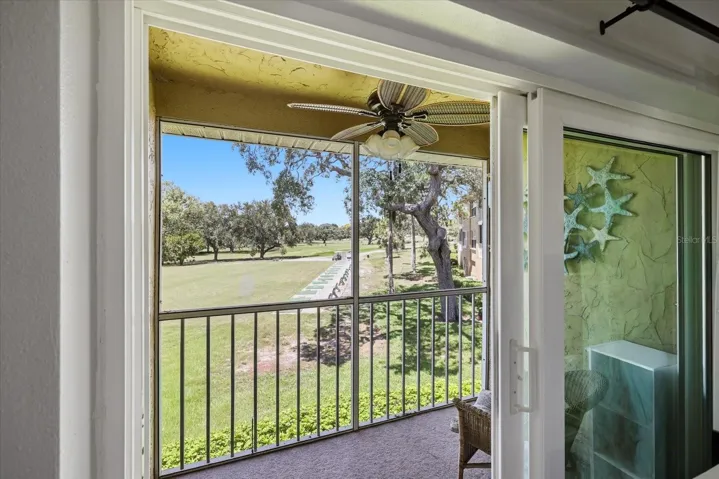 2026 Hurricane rated sliders leading out to screened patio with storage closet and view of golf course.