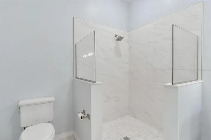 Primary Bathroom #1 features dual vanity sinks and walk in tiled shower
