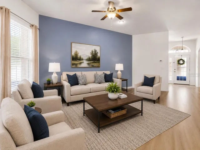 Virtually Staged-Living Room features built in entertainmen center and sliders to back lanai while overlooking the dining and kitchen.