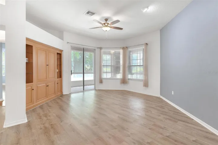 Living Room features built in entertainmen center and sliders to back lanai while overlooking the dining and kitchen.