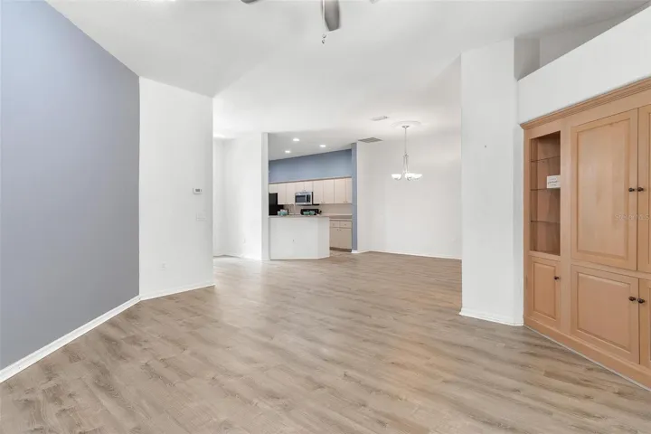 Living Room features built in entertainmen center and sliders to back lanai while overlooking the dining and kitchen.