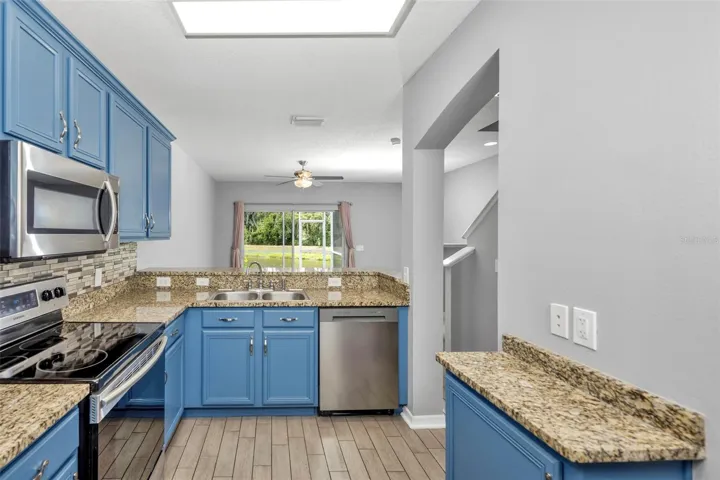 Upgraded kitchen with granite counters and stainless steel appliances