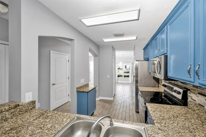 Upgraded kitchen with granite counters and stainless steel appliances
