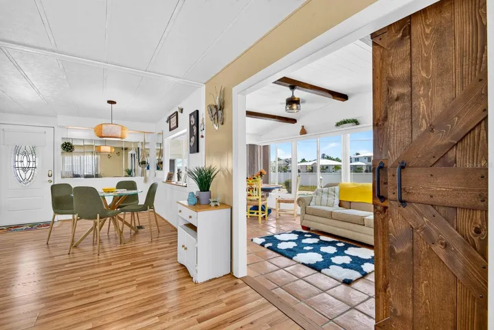 Sleek barn door showcasing the front lanai that is under a/c in the front and open to home