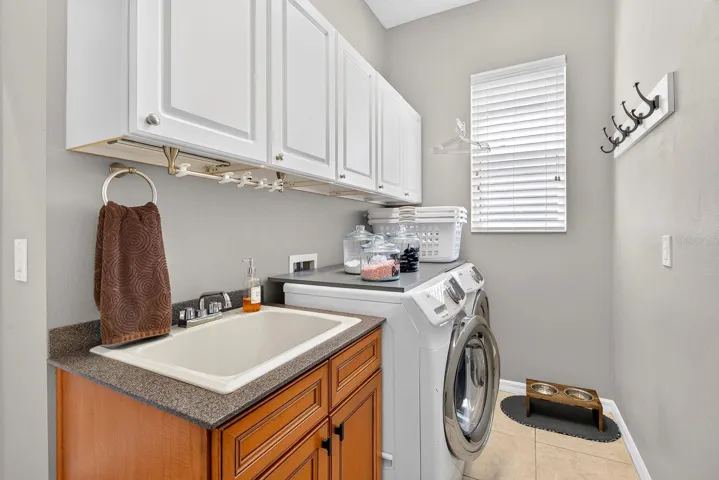 Laundry area with cabinets and sink