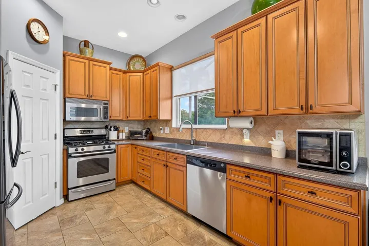 Another view of kitchen with window overlooking pool